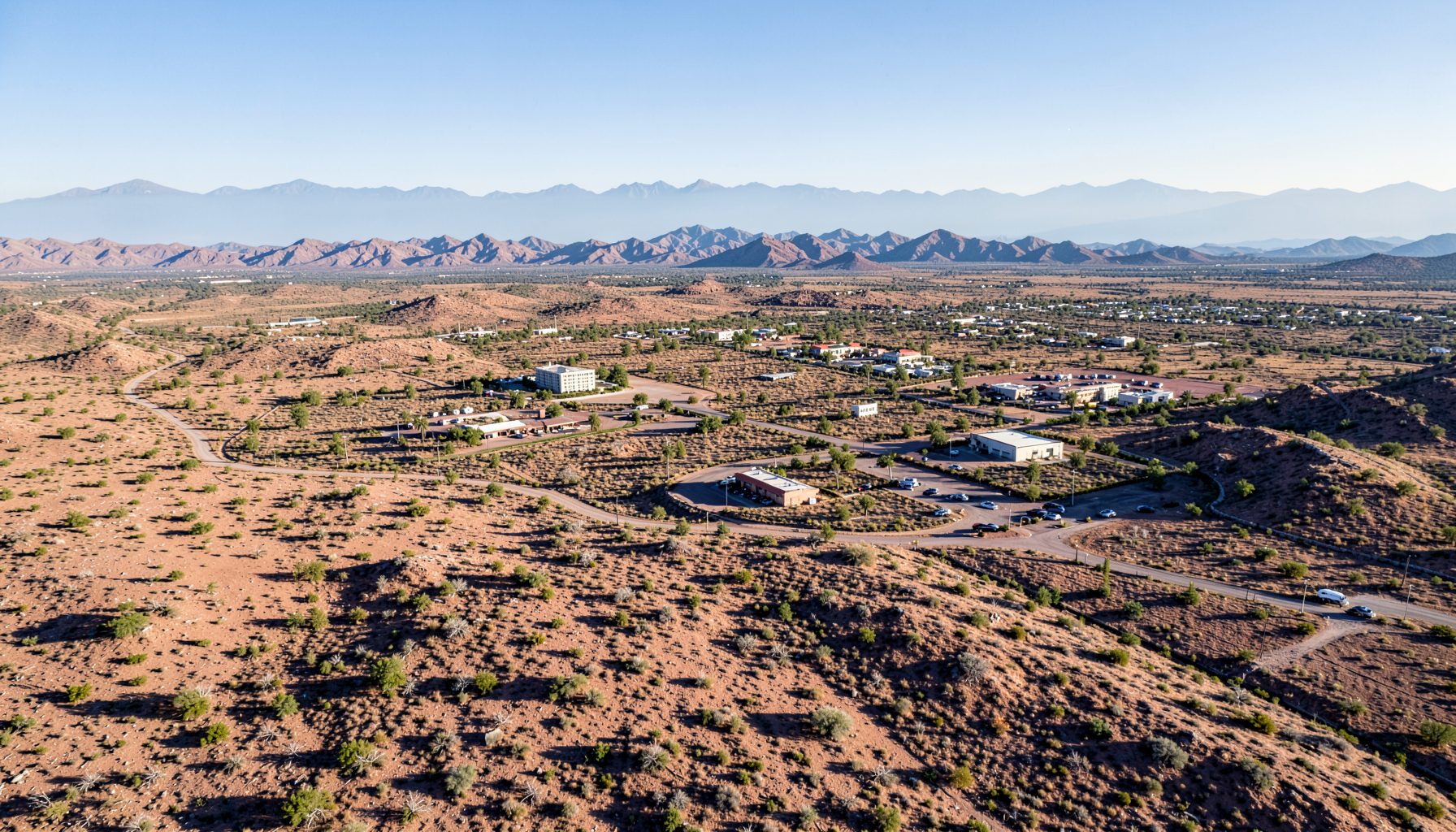 Aerial-style view of the El Paso landscape with wide desert terrain and mountain silhouettes under a clear sky, conveying the broad regional reach of the clinics